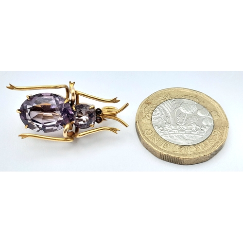79 - AN ANTIQUE 9K GOLD AND AMETHYST BEETLE BROOCH .   4.2gms