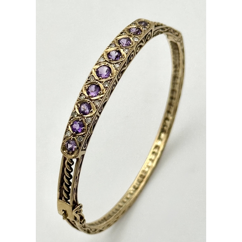 93 - A VINTAGE 9K GOLD HINGED BANGLE WITH DECORATIVE SIDES AND DIAMOND AND AMETHYST TOP STONES .    13.2g... 