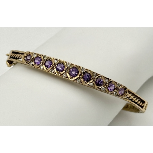 93 - A VINTAGE 9K GOLD HINGED BANGLE WITH DECORATIVE SIDES AND DIAMOND AND AMETHYST TOP STONES .    13.2g... 
