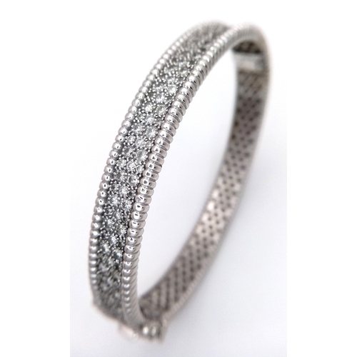 1168 - A 14K WHITE GOLD, DIAMOND SET BANGLE. 4.50 CTW. 29.2G. TAN 7001