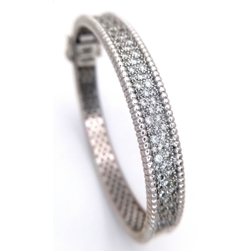 1168 - A 14K WHITE GOLD, DIAMOND SET BANGLE. 4.50 CTW. 29.2G. TAN 7001
