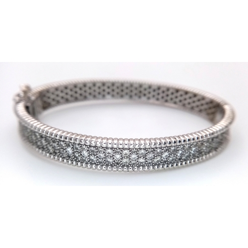 1168 - A 14K WHITE GOLD, DIAMOND SET BANGLE. 4.50 CTW. 29.2G. TAN 7001
