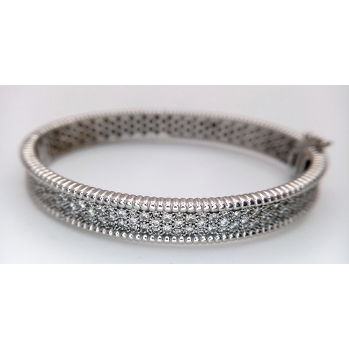 1168 - A 14K WHITE GOLD, DIAMOND SET BANGLE. 4.50 CTW. 29.2G. TAN 7001