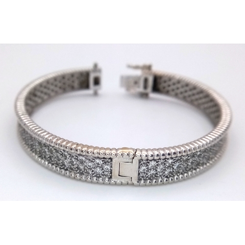 1168 - A 14K WHITE GOLD, DIAMOND SET BANGLE. 4.50 CTW. 29.2G. TAN 7001