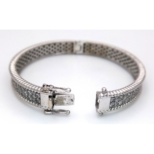 1168 - A 14K WHITE GOLD, DIAMOND SET BANGLE. 4.50 CTW. 29.2G. TAN 7001