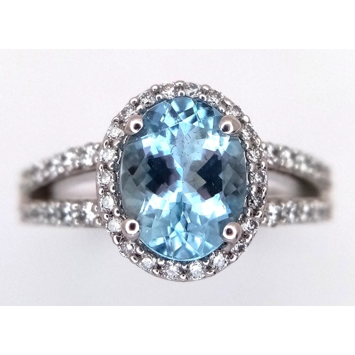 1175 - AN 18K WHITE GOLD, DIAMOND AND AQUAMARINE SET, SPLIT SHANK RING. 0.50 CTW OF DIAMONDS WITH A 2.00 CT... 