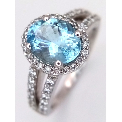 1175 - AN 18K WHITE GOLD, DIAMOND AND AQUAMARINE SET, SPLIT SHANK RING. 0.50 CTW OF DIAMONDS WITH A 2.00 CT... 