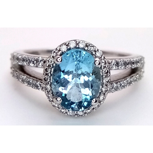 1175 - AN 18K WHITE GOLD, DIAMOND AND AQUAMARINE SET, SPLIT SHANK RING. 0.50 CTW OF DIAMONDS WITH A 2.00 CT... 