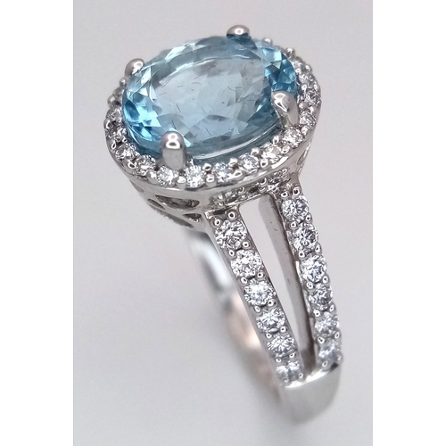 1175 - AN 18K WHITE GOLD, DIAMOND AND AQUAMARINE SET, SPLIT SHANK RING. 0.50 CTW OF DIAMONDS WITH A 2.00 CT... 