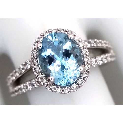 1175 - AN 18K WHITE GOLD, DIAMOND AND AQUAMARINE SET, SPLIT SHANK RING. 0.50 CTW OF DIAMONDS WITH A 2.00 CT... 
