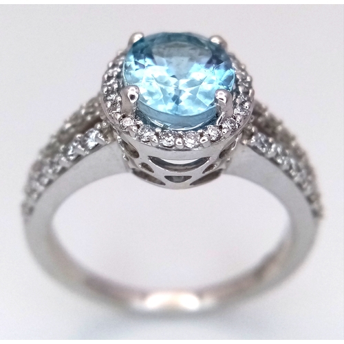 1175 - AN 18K WHITE GOLD, DIAMOND AND AQUAMARINE SET, SPLIT SHANK RING. 0.50 CTW OF DIAMONDS WITH A 2.00 CT... 