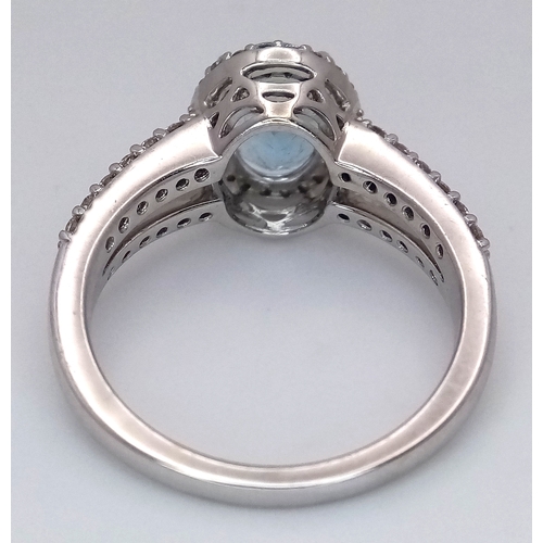 1175 - AN 18K WHITE GOLD, DIAMOND AND AQUAMARINE SET, SPLIT SHANK RING. 0.50 CTW OF DIAMONDS WITH A 2.00 CT... 