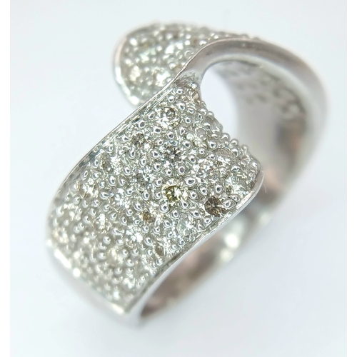 1258 - A 9K WHITE GOLD, DIAMOND SET, FANCY WAVE DESIGN RING. 1.25 CTW. 7.6G, SIZE N/O. SPSA 1002