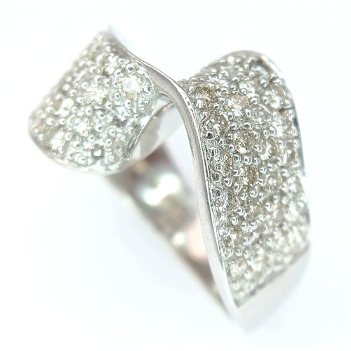 1258 - A 9K WHITE GOLD, DIAMOND SET, FANCY WAVE DESIGN RING. 1.25 CTW. 7.6G, SIZE N/O. SPSA 1002
