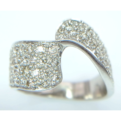 1258 - A 9K WHITE GOLD, DIAMOND SET, FANCY WAVE DESIGN RING. 1.25 CTW. 7.6G, SIZE N/O. SPSA 1002