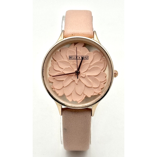 1189 - A BELLE AND BEAU, ROSE GOLD TONE, FLOWER DIAL, PINK STRAP WATCH. IN FULL WORKING ORDER. NEW BATTERY ... 