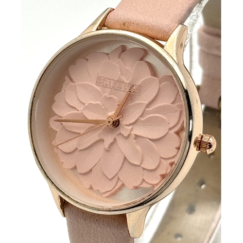 1189 - A BELLE AND BEAU, ROSE GOLD TONE, FLOWER DIAL, PINK STRAP WATCH. IN FULL WORKING ORDER. NEW BATTERY ... 