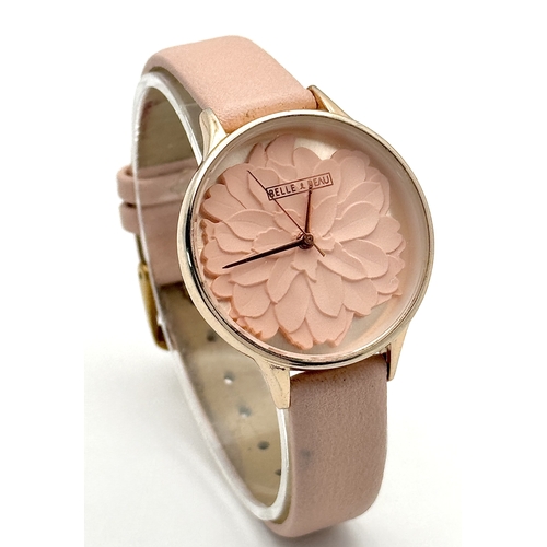 1189 - A BELLE AND BEAU, ROSE GOLD TONE, FLOWER DIAL, PINK STRAP WATCH. IN FULL WORKING ORDER. NEW BATTERY ... 