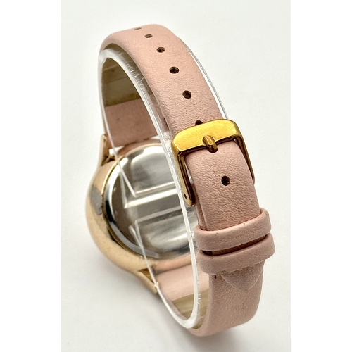 1189 - A BELLE AND BEAU, ROSE GOLD TONE, FLOWER DIAL, PINK STRAP WATCH. IN FULL WORKING ORDER. NEW BATTERY ... 