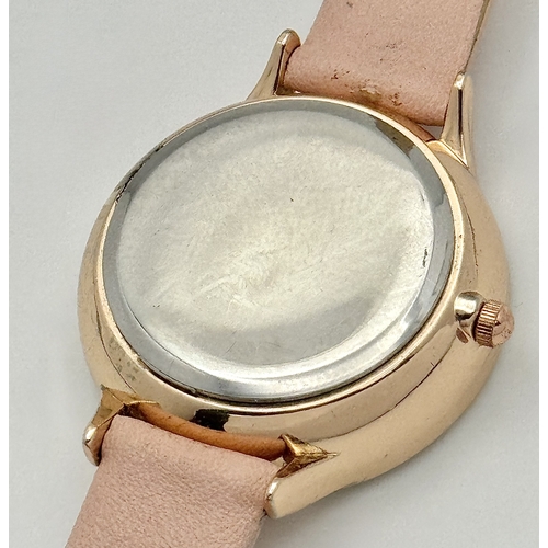 1189 - A BELLE AND BEAU, ROSE GOLD TONE, FLOWER DIAL, PINK STRAP WATCH. IN FULL WORKING ORDER. NEW BATTERY ... 