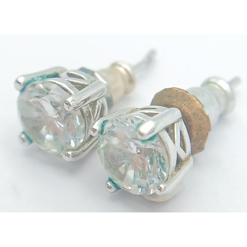 633 - A PAIR OF CZ STUD EARRINGS SET IN 9K WHITE GOLD .1.6gms