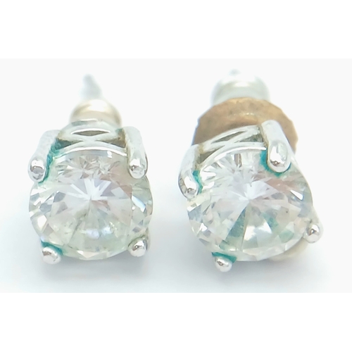 633 - A PAIR OF CZ STUD EARRINGS SET IN 9K WHITE GOLD .1.6gms