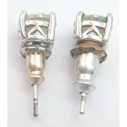 633 - A PAIR OF CZ STUD EARRINGS SET IN 9K WHITE GOLD .1.6gms