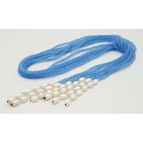 654 - An Aquamarine and Freshwater Pearl Three Strand Scarf Necklace. 123cm strands.