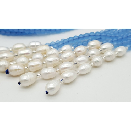 654 - An Aquamarine and Freshwater Pearl Three Strand Scarf Necklace. 123cm strands.