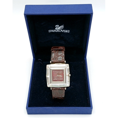 684 - A SWAROVSKI, BROWN LEATHER STRAP WATCH. IN A SWAROVSKI BOX. IN FULL WORKING ORDER. NEW BATTERY FITTE... 
