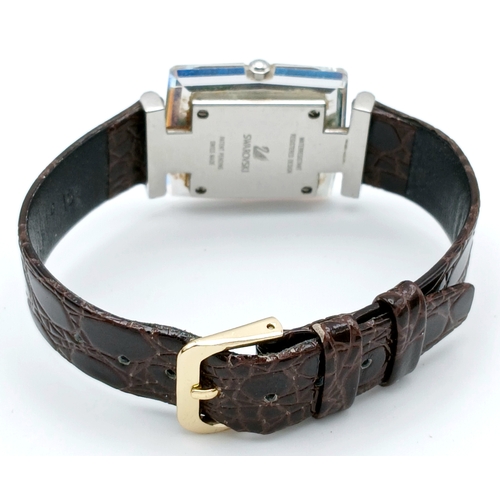 684 - A SWAROVSKI, BROWN LEATHER STRAP WATCH. IN A SWAROVSKI BOX. IN FULL WORKING ORDER. NEW BATTERY FITTE... 