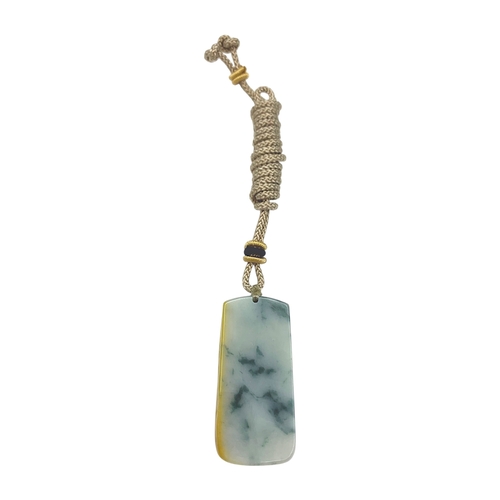 697 - A Jade Pendant Necklace.The stone shows contrasting pale celadon and darker green tones. Suspended f... 