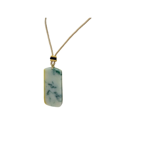 697 - A Jade Pendant Necklace.The stone shows contrasting pale celadon and darker green tones. Suspended f... 
