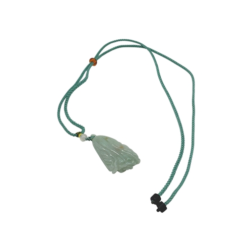 725 - A Jade Pendant Necklace. The celadon-green jade pendant finely carved in a flowing, organic form, su... 
