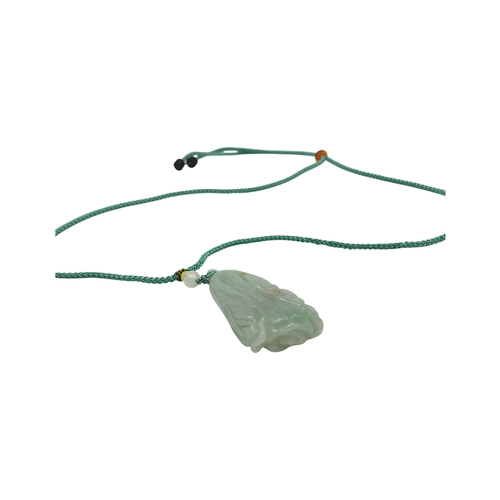 725 - A Jade Pendant Necklace. The celadon-green jade pendant finely carved in a flowing, organic form, su... 