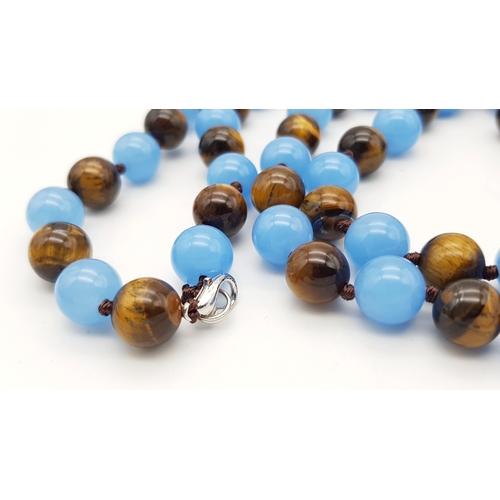 661 - A Light Blue Jade and Tigers Eye Beaded Matinee Necklace. 10mm beads. 92cm necklace length.