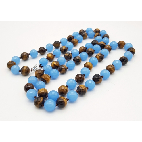 661 - A Light Blue Jade and Tigers Eye Beaded Matinee Necklace. 10mm beads. 92cm necklace length.