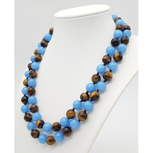 661 - A Light Blue Jade and Tigers Eye Beaded Matinee Necklace. 10mm beads. 92cm necklace length.
