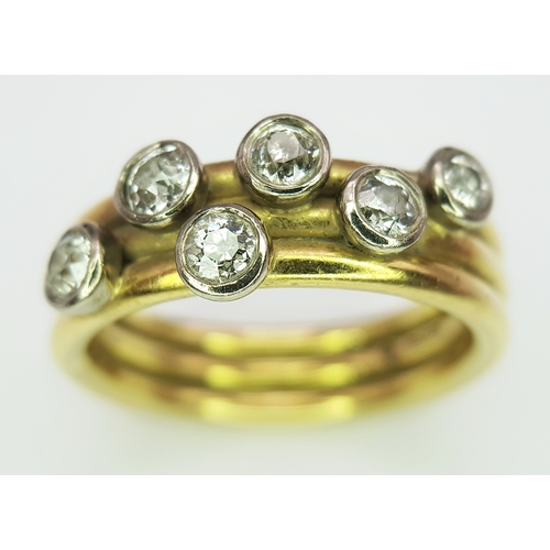 20 - An 18K Yellow Gold Diamond Orbital Ring. Three row construction with six orbiting diamond set stars ... 