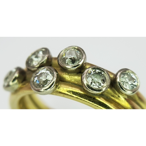 20 - An 18K Yellow Gold Diamond Orbital Ring. Three row construction with six orbiting diamond set stars ... 