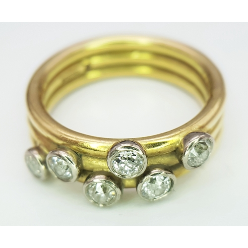 20 - An 18K Yellow Gold Diamond Orbital Ring. Three row construction with six orbiting diamond set stars ... 