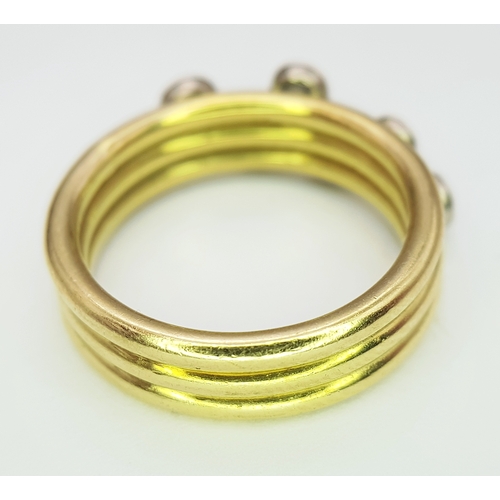 20 - An 18K Yellow Gold Diamond Orbital Ring. Three row construction with six orbiting diamond set stars ... 