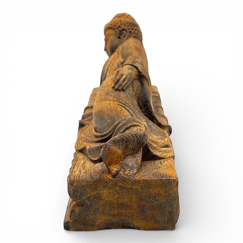 1201 - A magnificent Natural agarwood hand carved  of a reclining Buddha resting on a lotus platform.
The n... 