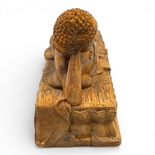 1201 - A magnificent Natural agarwood hand carved  of a reclining Buddha resting on a lotus platform.
The n... 