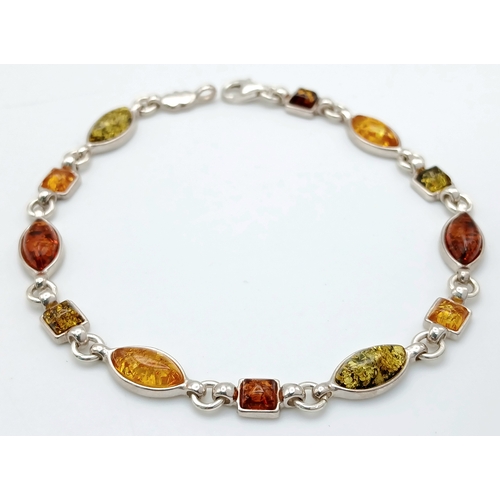 1260 - A Baltic Amber Multi-Colour Link Bracelet. Silver settings. Measured 20cm as flat. Never worn. Made ... 