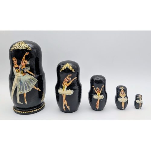 1267 - A Russian Swan Lake Ballet Nesting Doll Set, comprising five wooden dolls. Each piece fits neatly wi... 