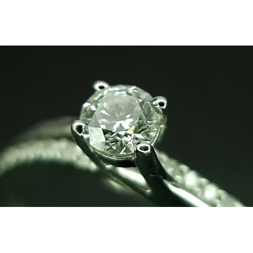 25 - An 18K White Gold Diamond Ring. A round brilliant cut 0.25ct diamond having G-H colour with VS2 clar... 
