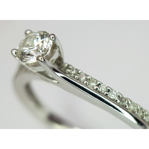 25 - An 18K White Gold Diamond Ring. A round brilliant cut 0.25ct diamond having G-H colour with VS2 clar... 