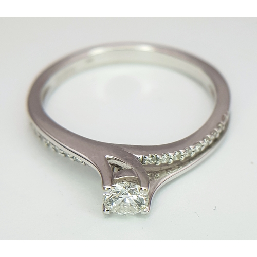 25 - An 18K White Gold Diamond Ring. A round brilliant cut 0.25ct diamond having G-H colour with VS2 clar... 