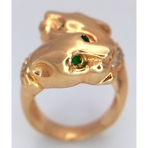 37 - A 14K Yellow Gold, Emerald and Diamond Twin Panther Crossover Ring. Emerald eyes and diamond set nec... 
